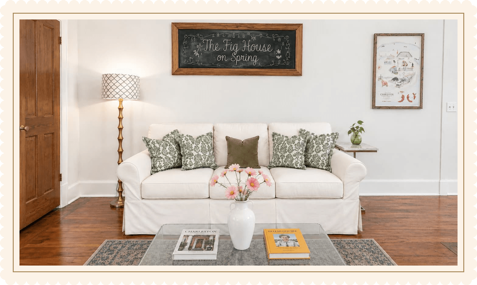 The living room of The Fig House on Spring, slipcovered sofa beneath the hand-lettered chalkboard