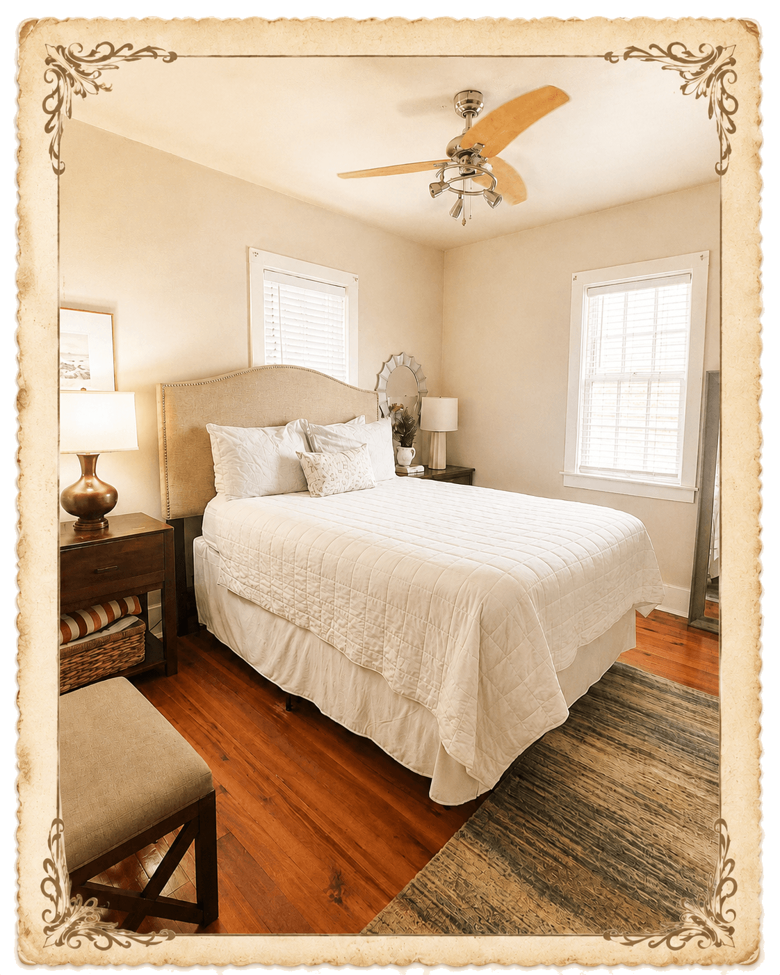 Third bedroom - queen bed with cream quilted bedding, upholstered headboard, sunburst mirror
